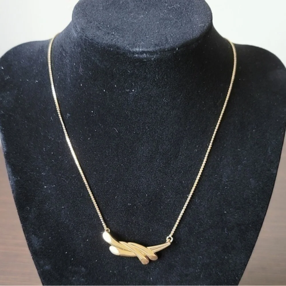 Golden necklace with modern pendant.